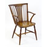 A late Georgian Windsor chair with a fanned back splat, a shaped seat and raised on turned