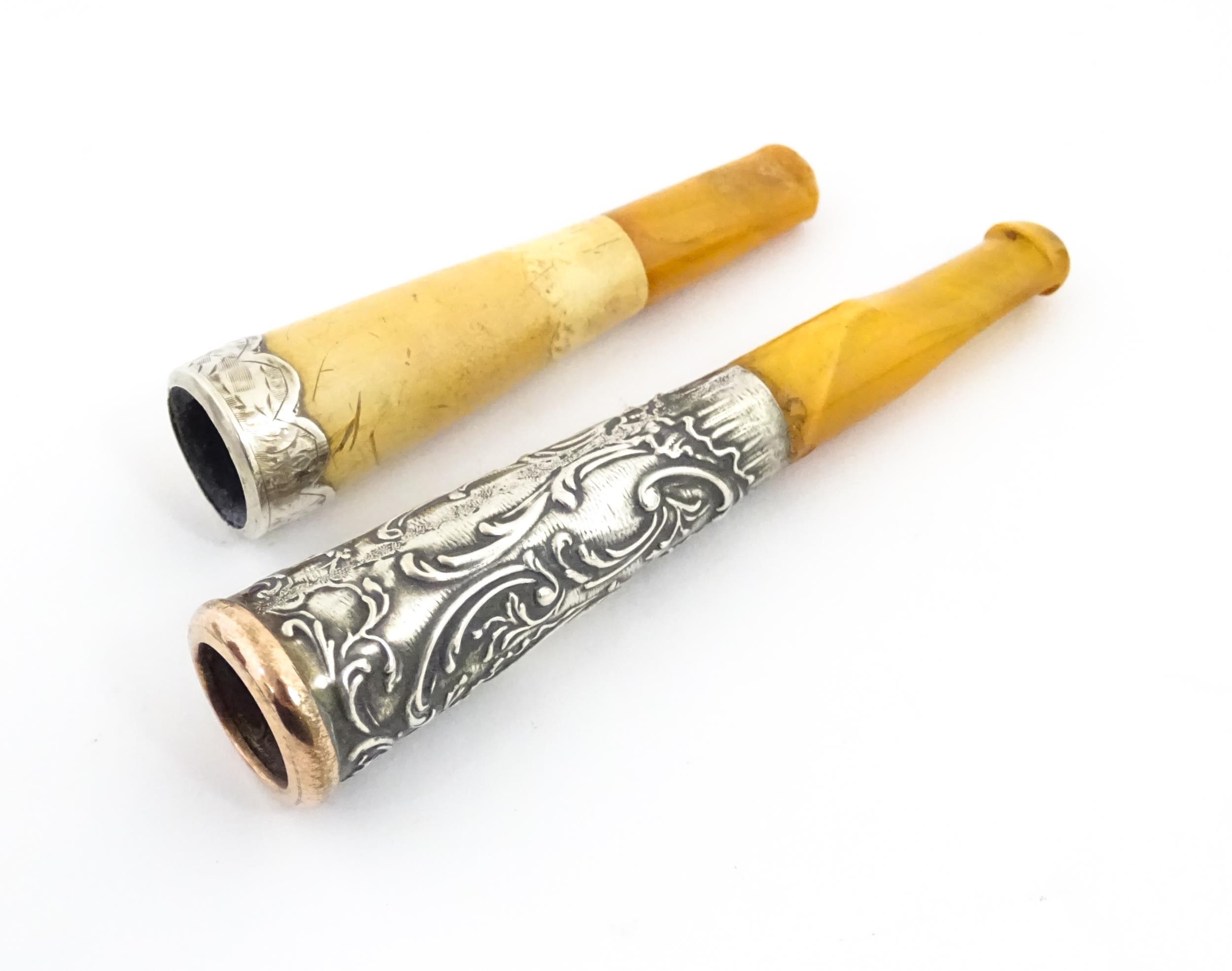 Two amber cheroot mouthpiece holders with white metal mounts, one with meerschaum detail. On - Image 4 of 8