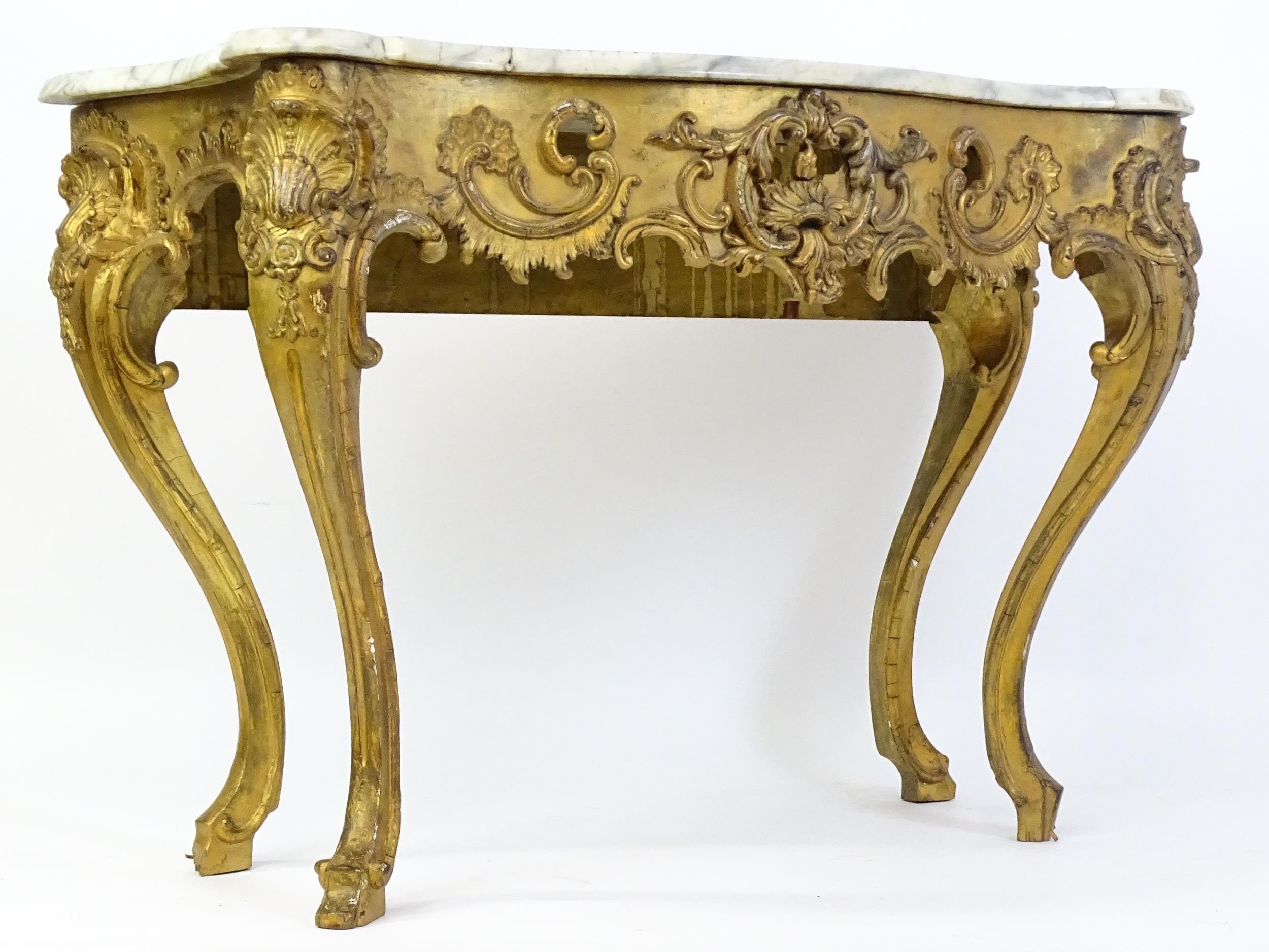 A 19thC marble topped table with a gesso and giltwood moulded base, decorated with shells, - Image 2 of 8