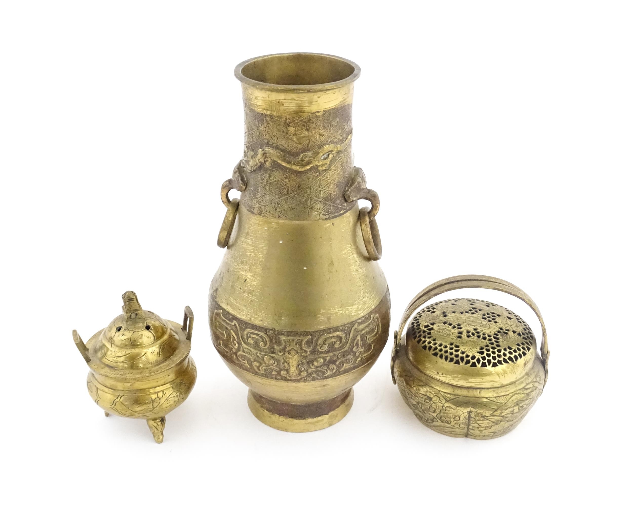 Three items of Chinese brass ware to include a baluster vase with twin ring handles decorated with