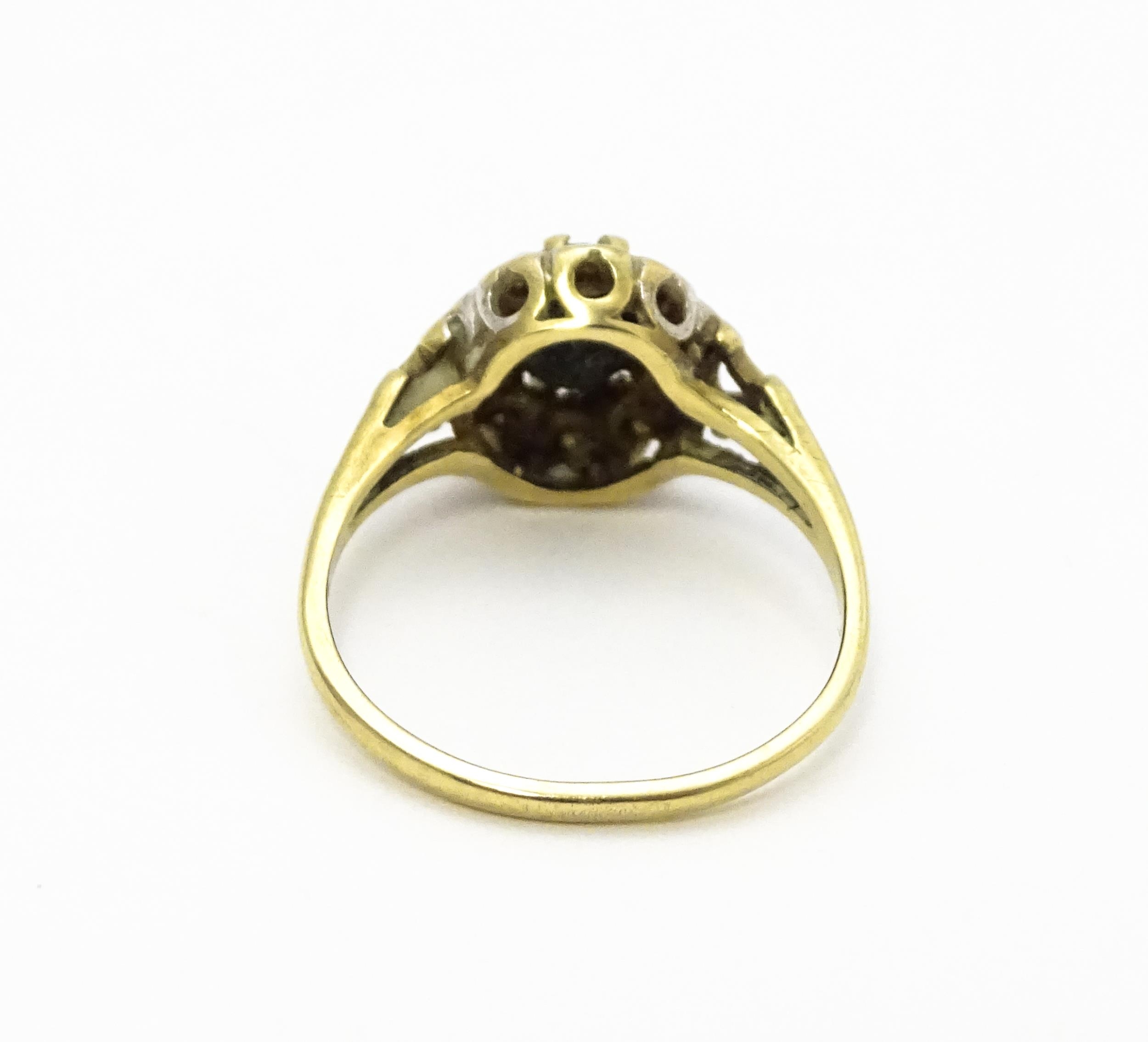 A 9ct gold ring set with central sapphire bordered by diamonds. Ring size approx. L 1/2 Please - Image 7 of 10
