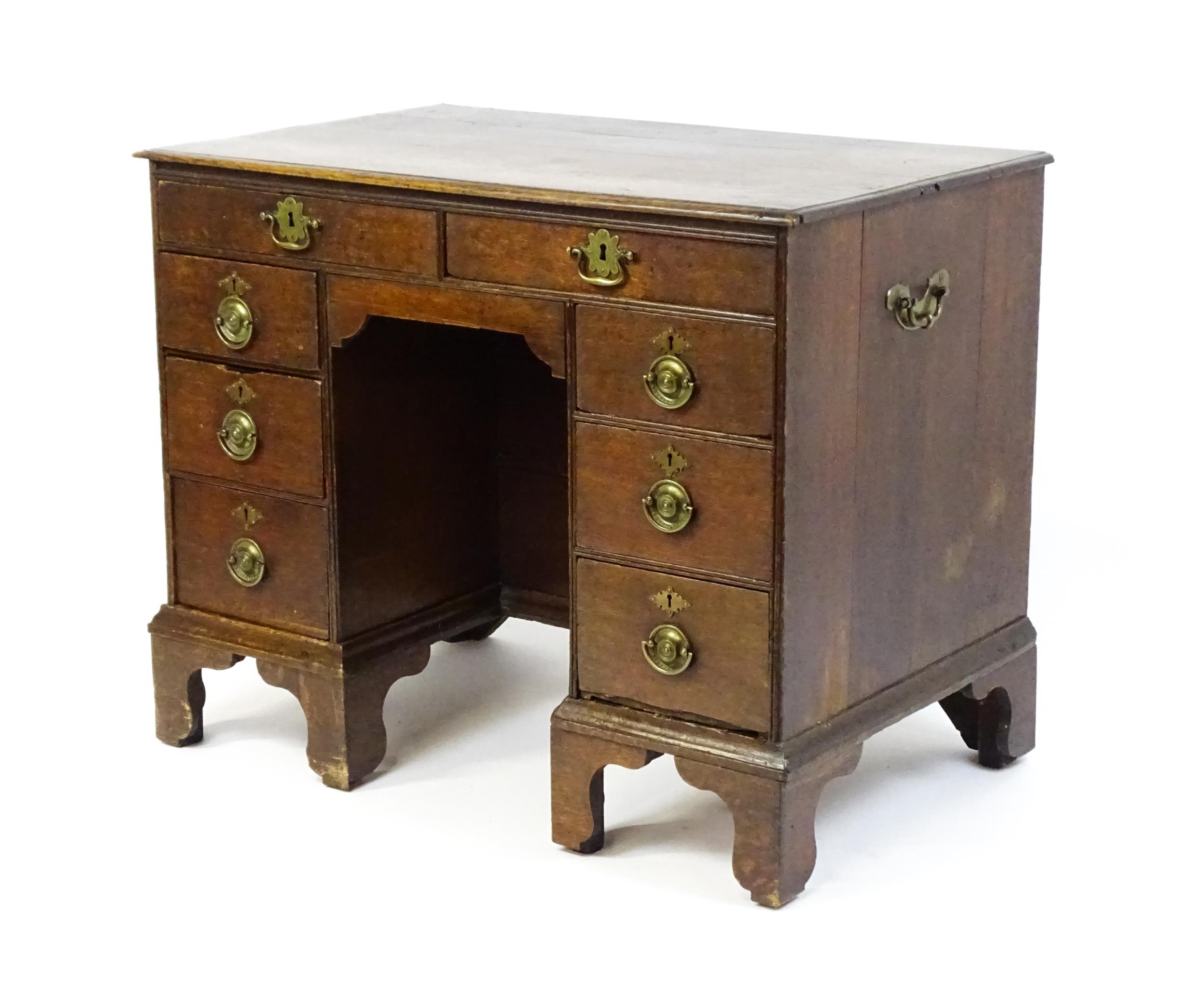 An early / mid 18thC oak kneehole desk with a moulded top above two short drawers and two banks of - Image 6 of 10