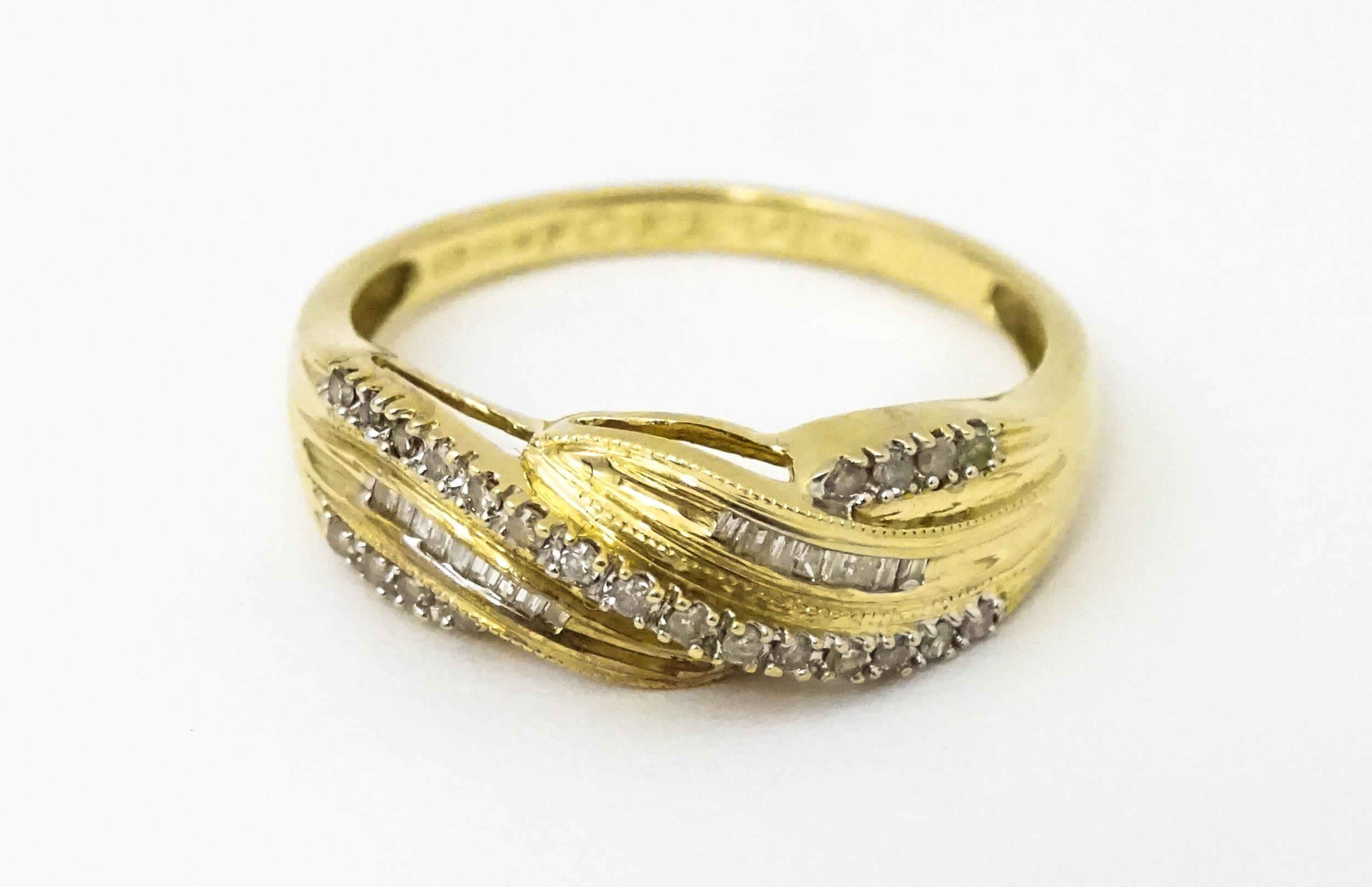 A 14ct gold with twist detail set with diamonds. Ring size approx. Q 1/2 Please Note - we do not