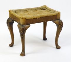 An early 20thC stool raised on four shell carved cabriole legs terminating in pad feet. 20" wide x