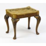 An early 20thC stool raised on four shell carved cabriole legs terminating in pad feet. 20" wide x