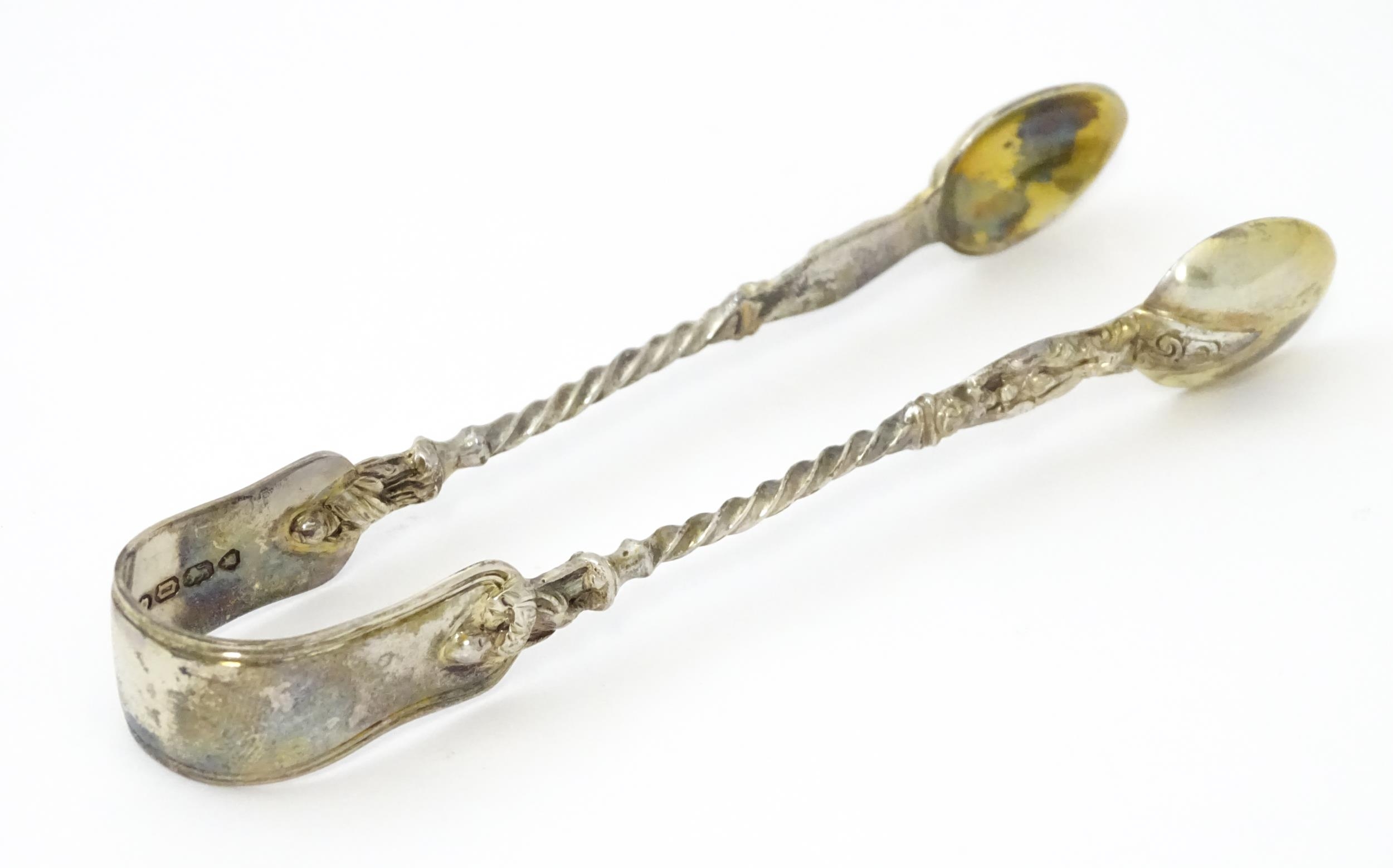 Victorian silver sugar tongs hallmarked London 1869, maker Henry Holland. Approx. 4 3/4" long Please