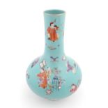 A Chinese famille rose vase with a turquoise ground decorated with figures and auspicious symbols.