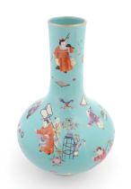 A Chinese famille rose vase with a turquoise ground decorated with figures and auspicious symbols.