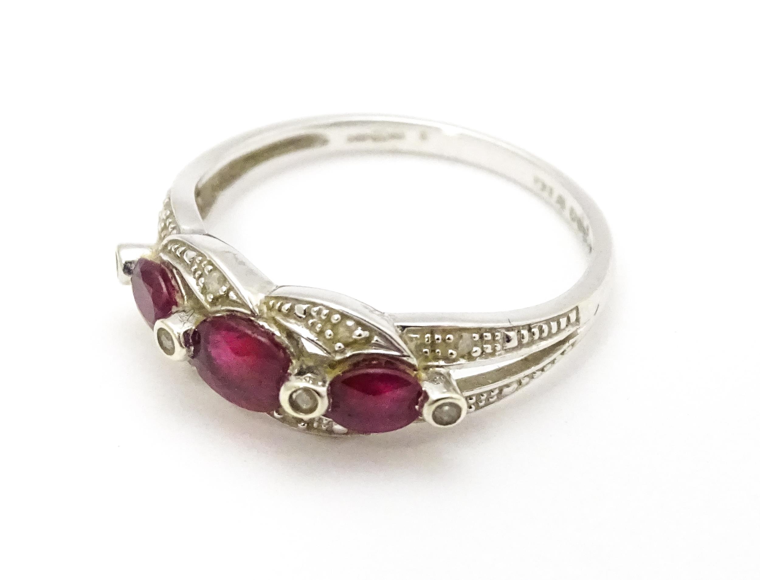 A 9ct white gold ring set with rubies and diamond. Ring size approx. M 1/2 Please Note - we do not - Image 4 of 7