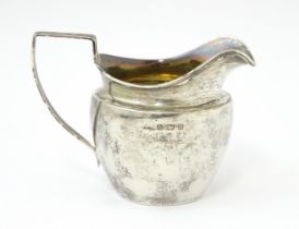 A silver cream jug hallmarked Birmingham 1900 maker Harry Hayes. Approx 3 1/2" high Please Note - we