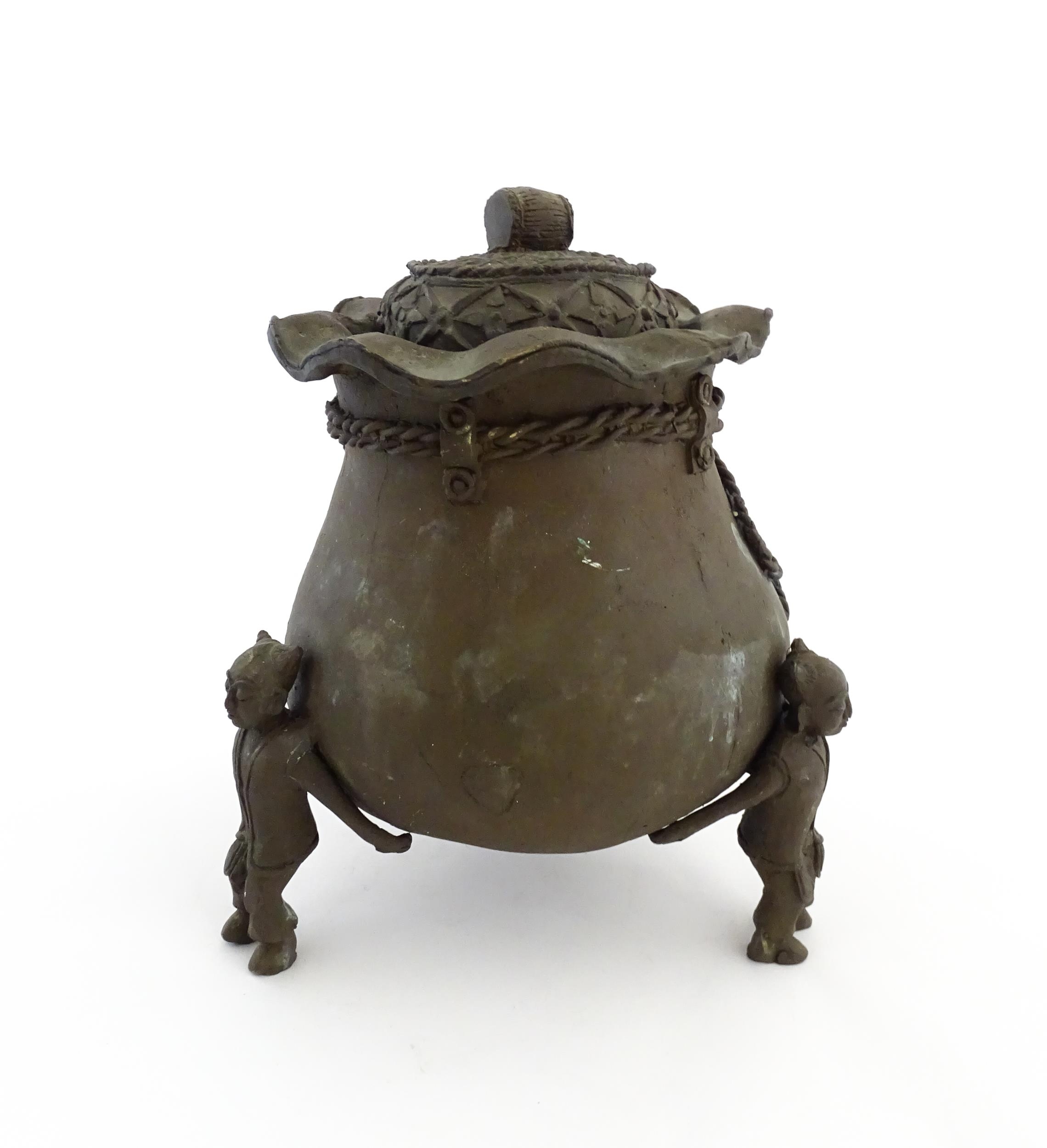A Chinese cast bronze pot and cover modelled as a money bag with rope tie supported by three figural - Image 5 of 10