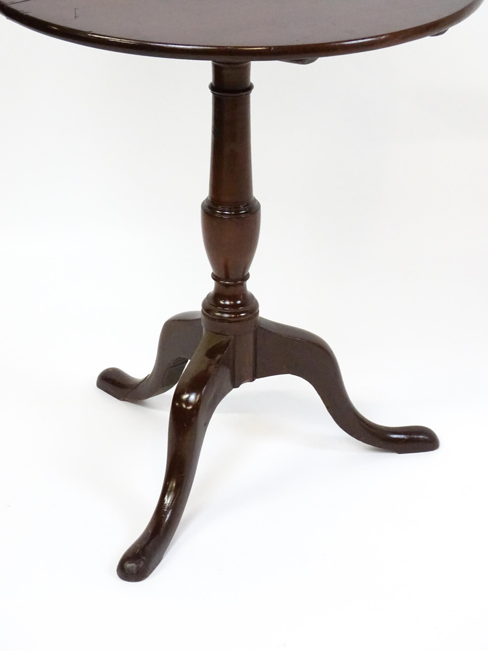 A 19thC mahogany tripod table with a turned pedestal above three cabriole legs. 27" high x 23" in - Image 2 of 5