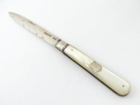 A silver folding fruit knife with mother of pearl handle hallmarked Sheffield 1906, maker C W