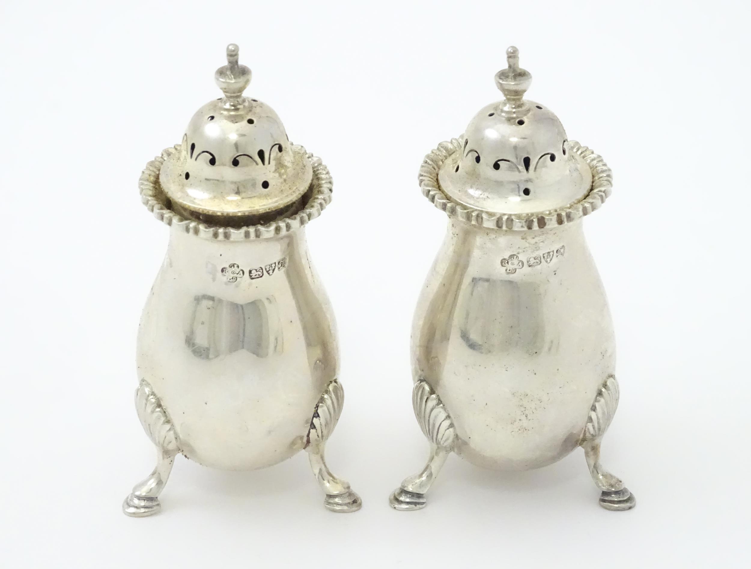 A pair of silver peppers hallmarked Chester 1911, maker Jay, Richard Attenborough Co Ltd. Approx.