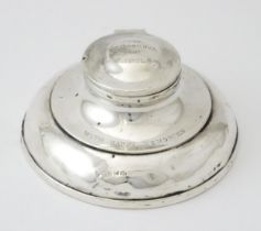 A silver inkwell of capstan form hallmarked Birmingham 1920, maker J Beach & Co. Approx. 4 1/2" wide