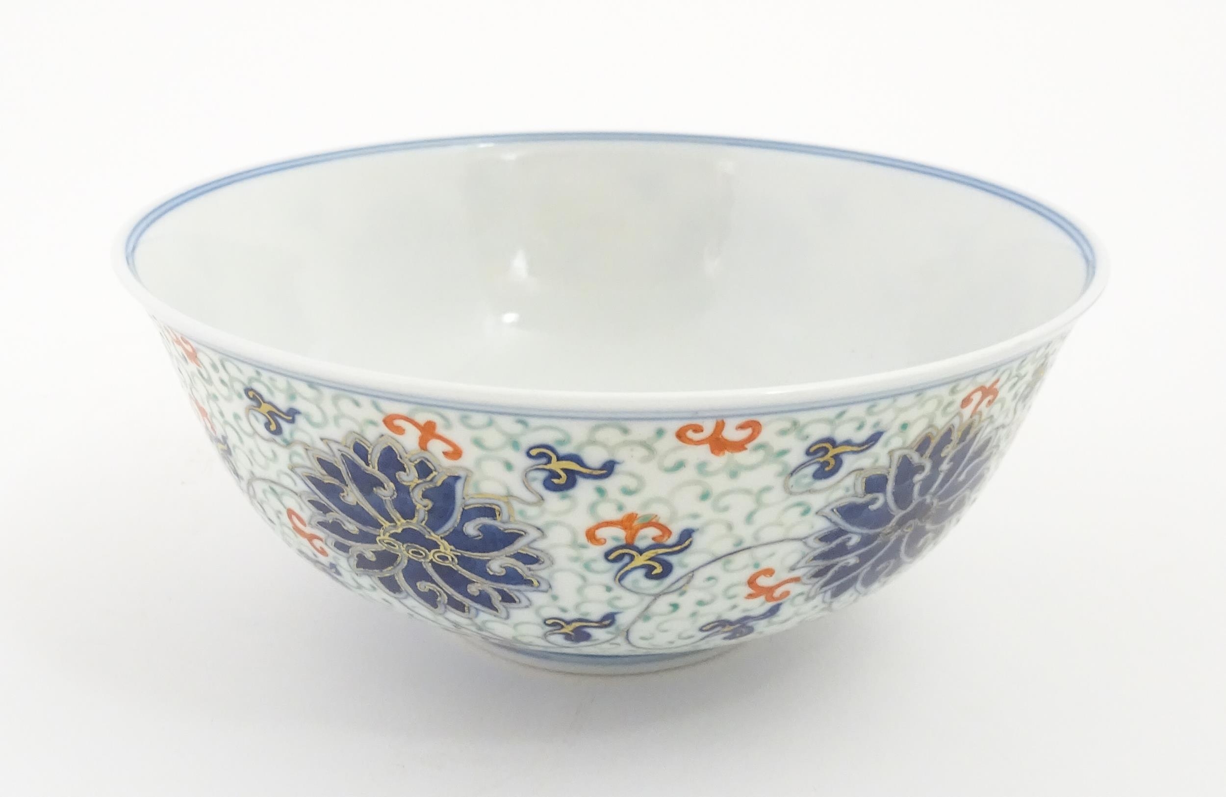 A Chinese bowl decorated with scrolling floral and foliate detail. Character marks under. Approx. 3" - Image 5 of 9