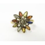 A 9ct gold ring set with central diamonds bordered by various coloured stones in a flower setting.