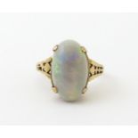 A 9ct gold ring set with large opal cabochon. The opal approx 3/4" long. Ring size approx. 0