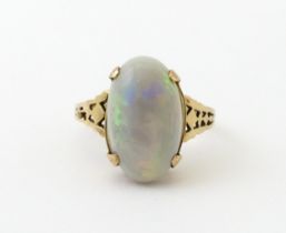 A 9ct gold ring set with large opal cabochon. The opal approx 3/4" long. Ring size approx. 0