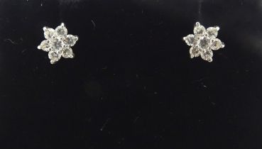 A pair of 9ct gold stud earrings set with diamond clusters. Approx. 1/4" wide Please Note - we do