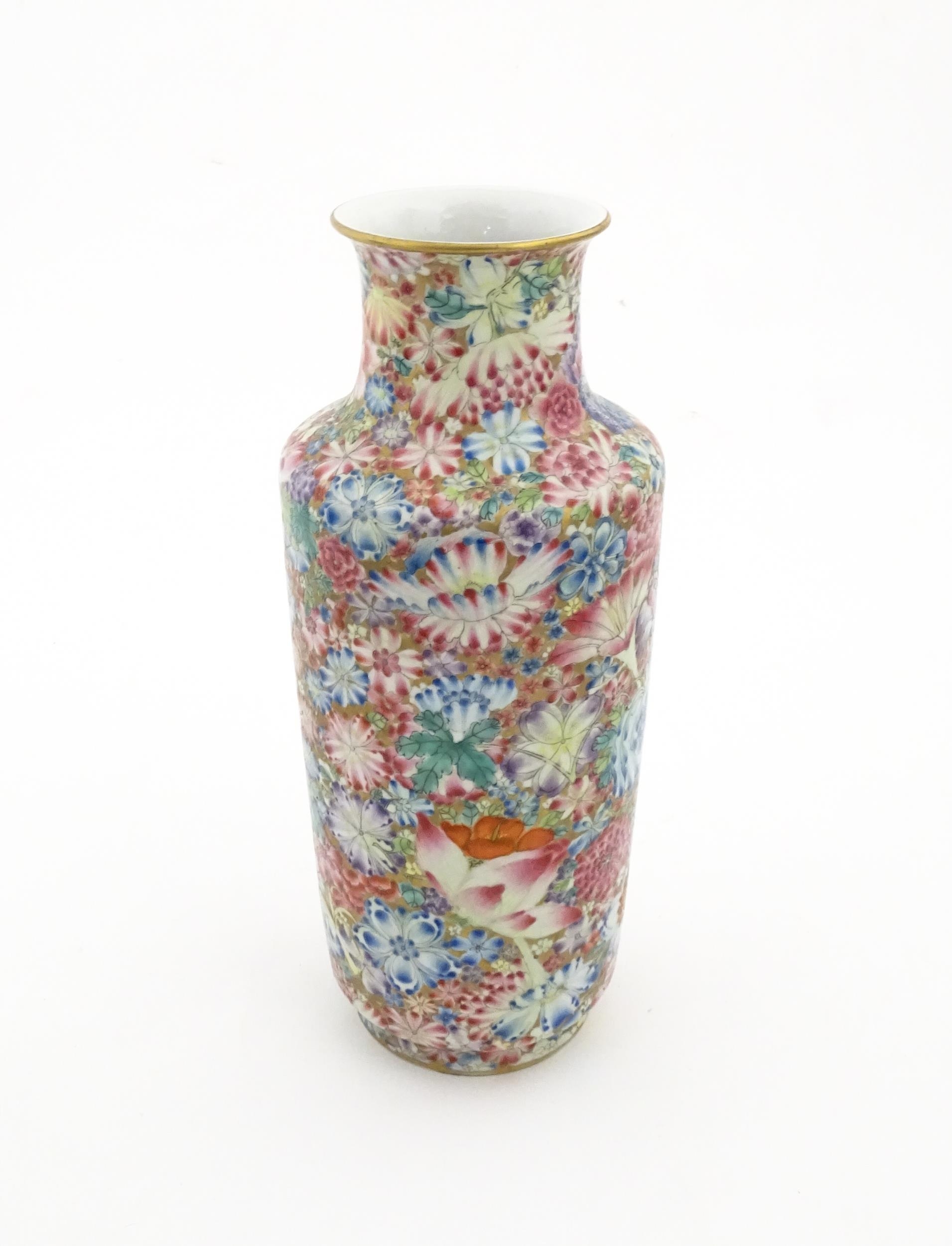 A Chinese famille rose vase decorated with a profusion of flowers. Character marks under. Approx. 10 - Image 5 of 6