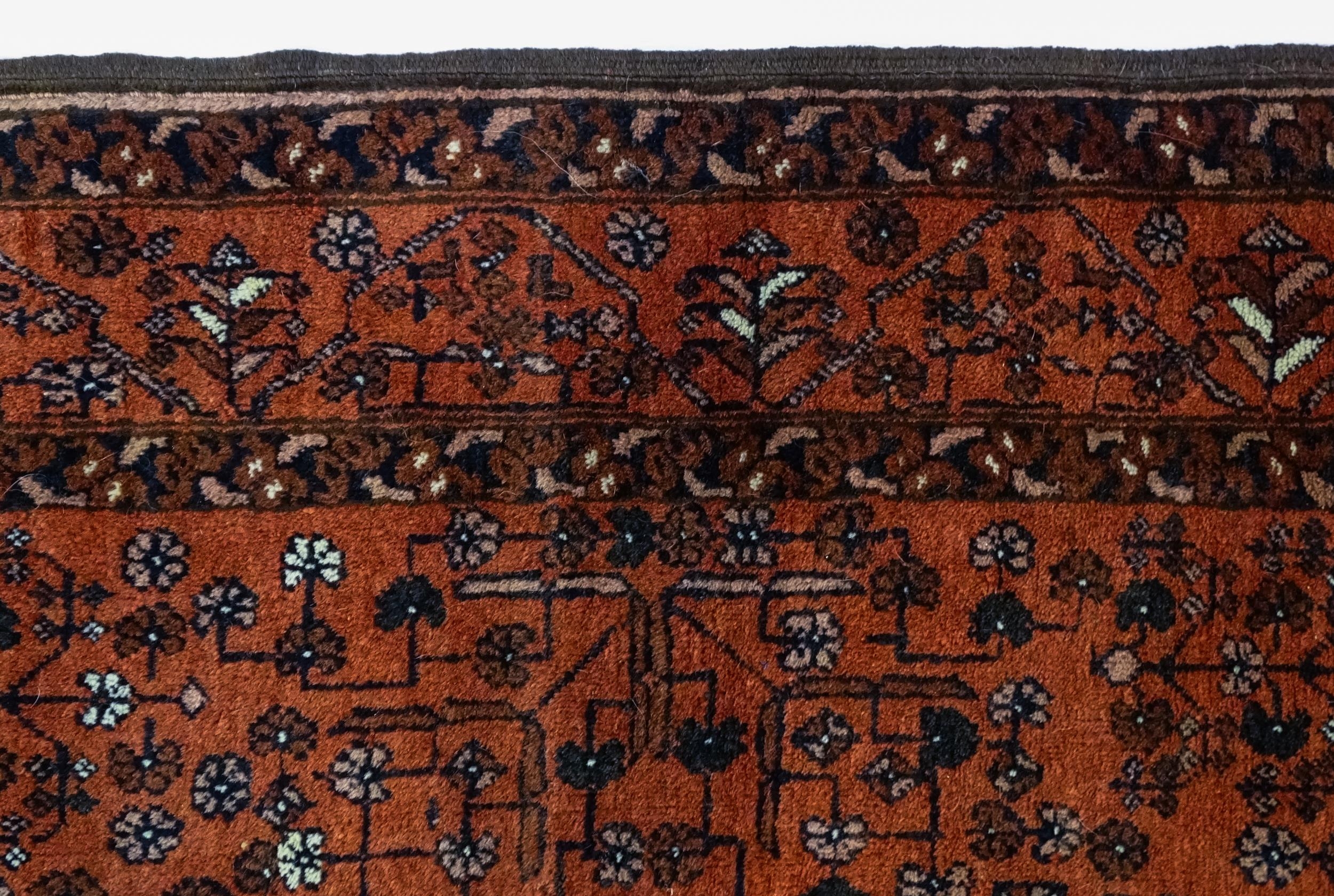 Carpet / Rug: A red ground rug decorated with floral and foliate detail, further repeated to - Image 4 of 8