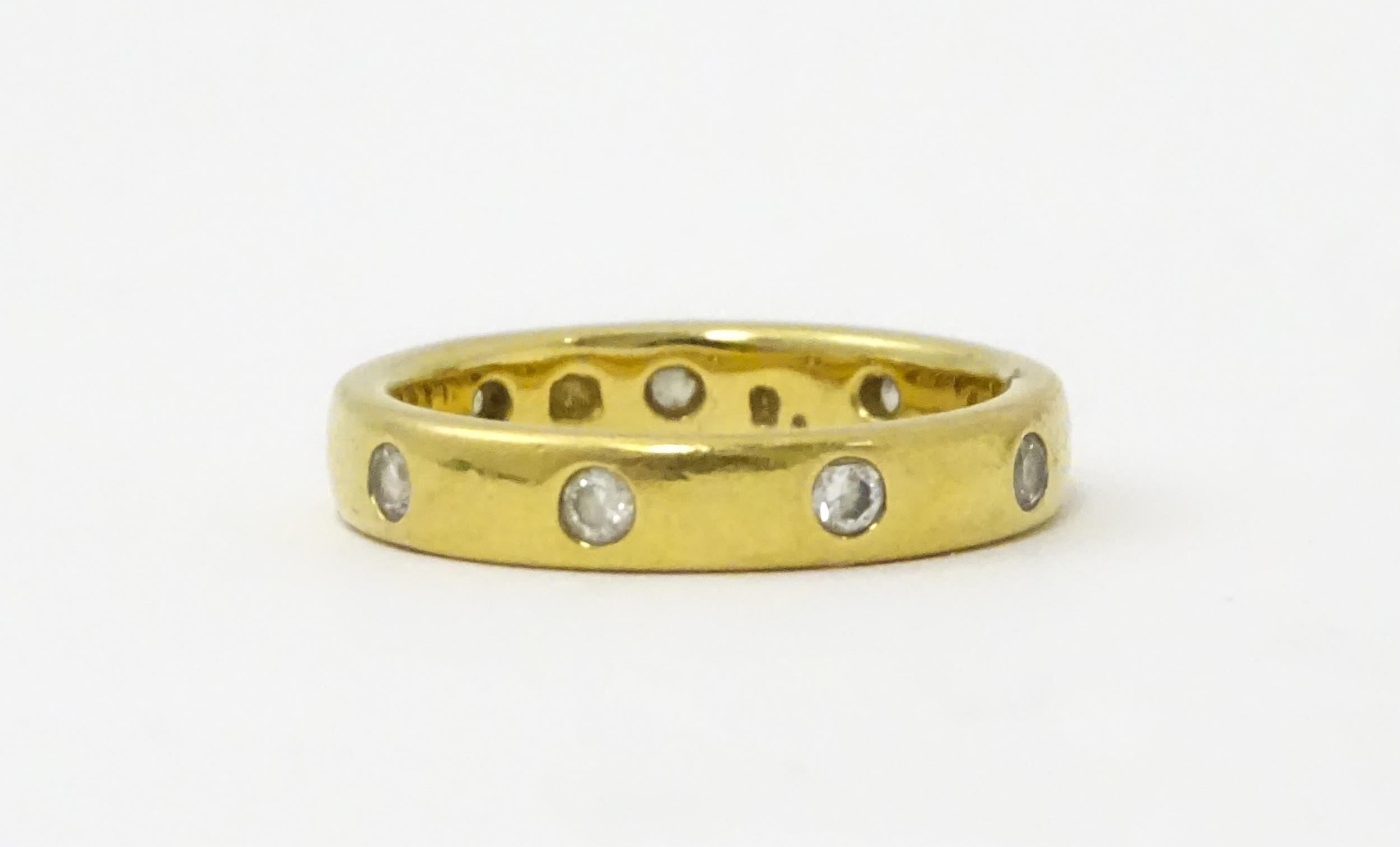 A yellow metal eternity ring set with white stones. Ring size approx. Q 1/2 Please Note - we do - Image 3 of 6