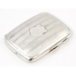 A silver cigarette case with banded engine turned decoration hallmarked Birmingham 1927, maker Henry