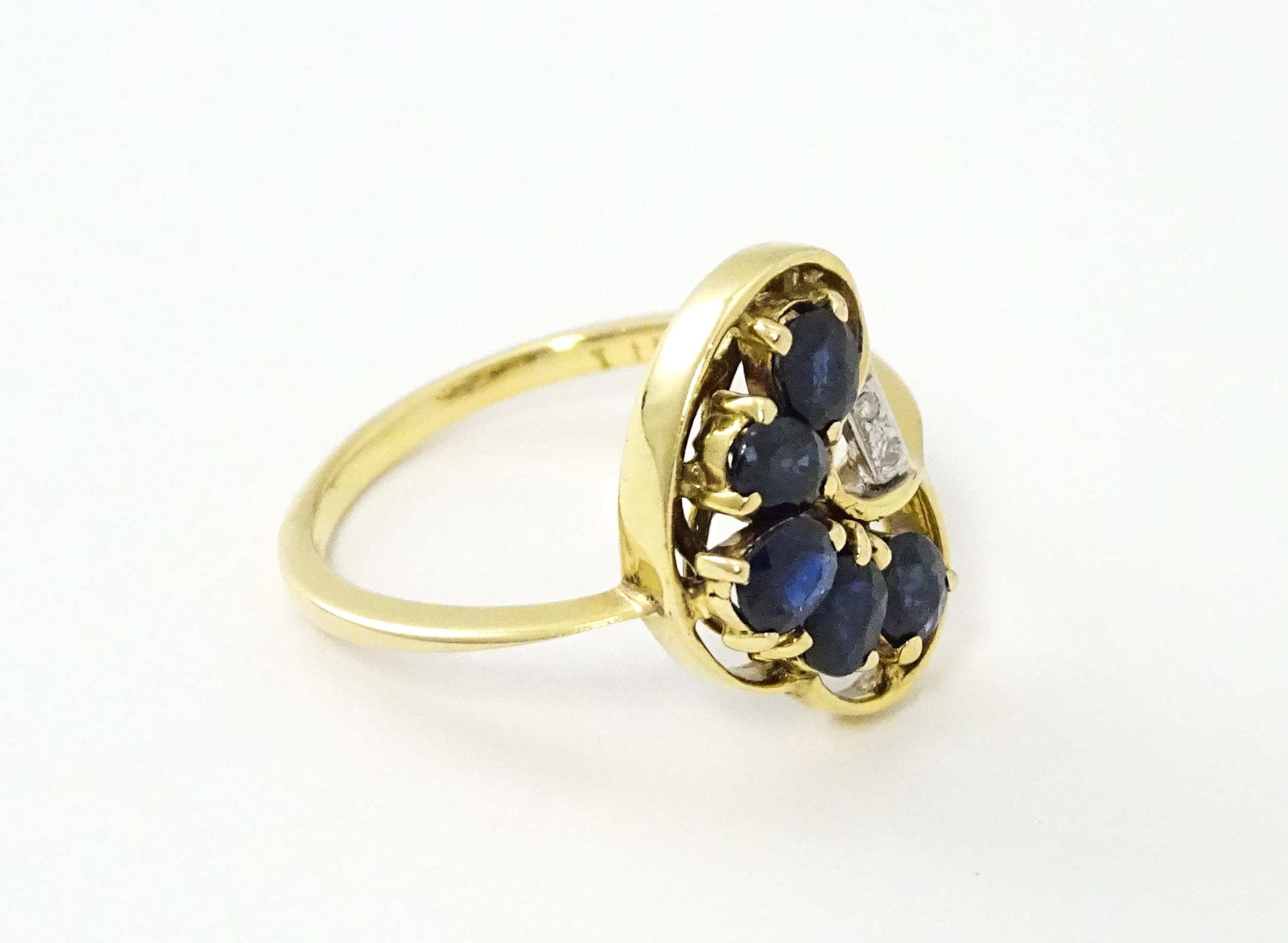 A 9ct gold ring set with 5 graduated blue spinel and two diamonds. Ring size approx. L 1/2 Please - Image 5 of 7