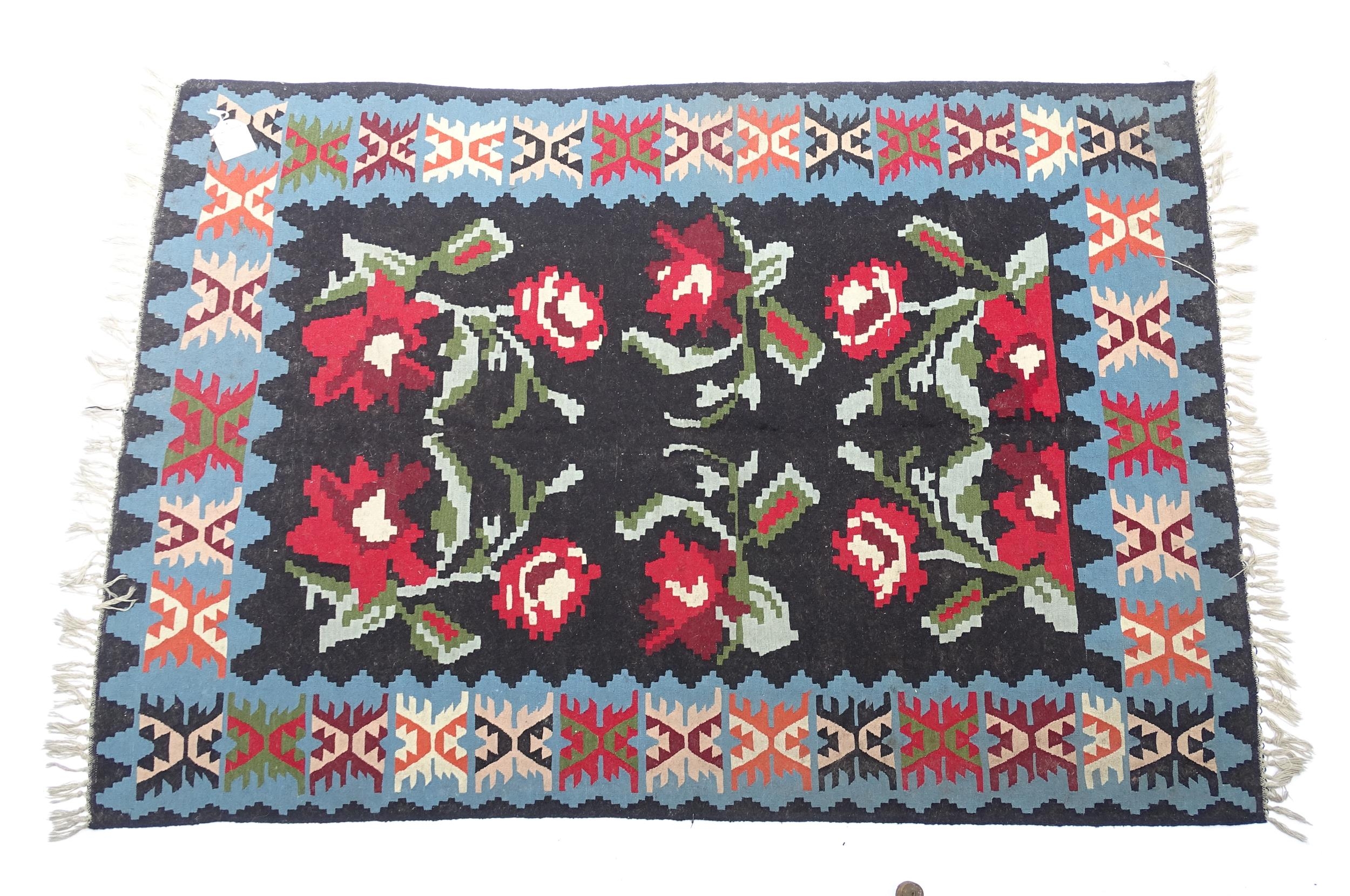 Carpet / Rug : A black ground rug with red floral decoration, with geometric motifs to borders. - Image 2 of 9