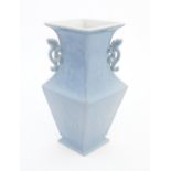 A Chinese vase of angular baluster form with a pale blue ground and twin handles, decorated with