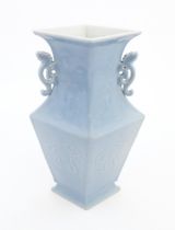 A Chinese vase of angular baluster form with a pale blue ground and twin handles, decorated with