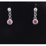 A pair of white gold drop earrings set with diamonds with pink sapphire drops. Approx. 1/2" long