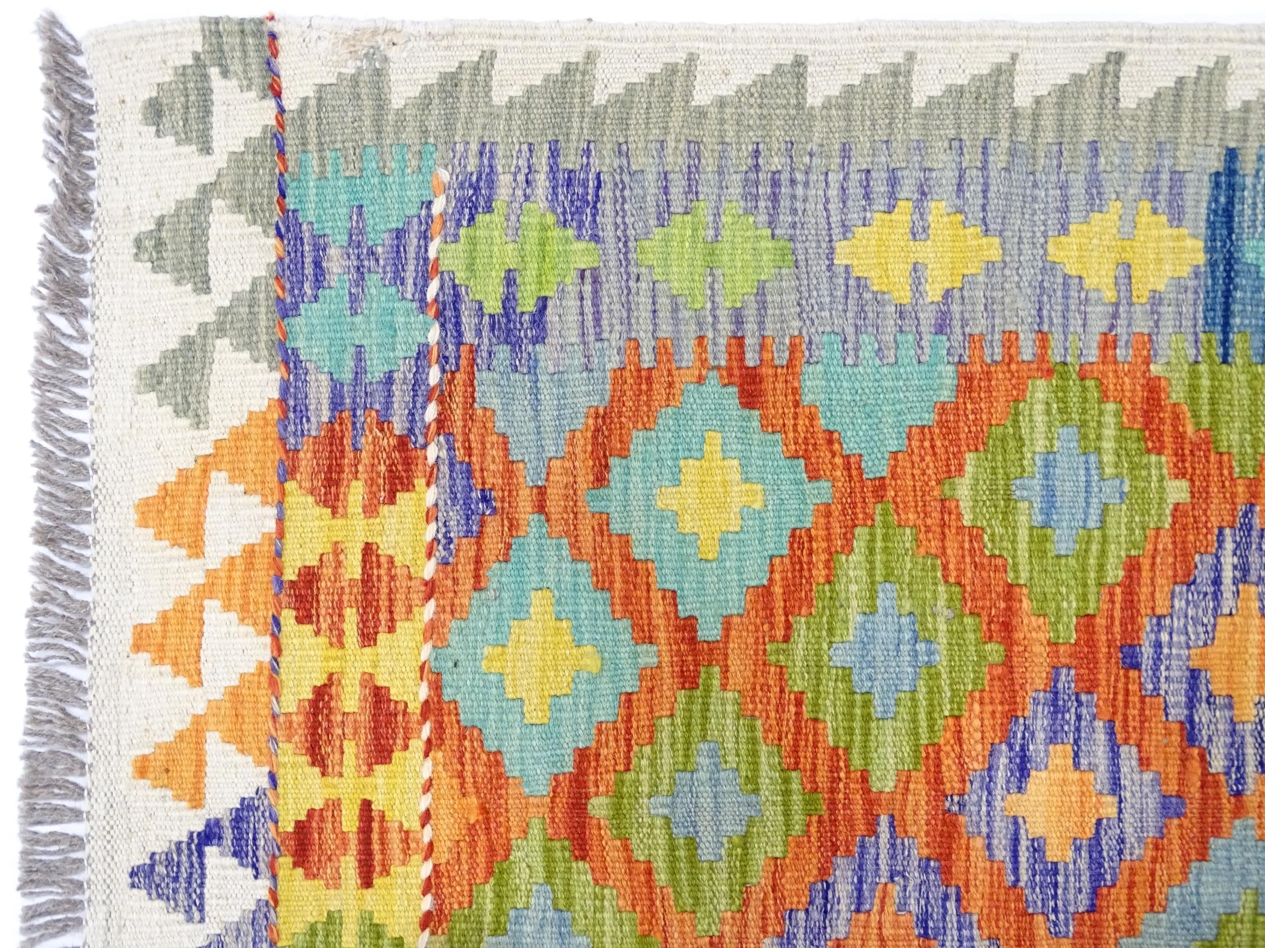 Carpet / Rug : A Turkish Anatolian kilim rug with repeated geometric motifs. Approx. 84" x 59" - Image 3 of 6