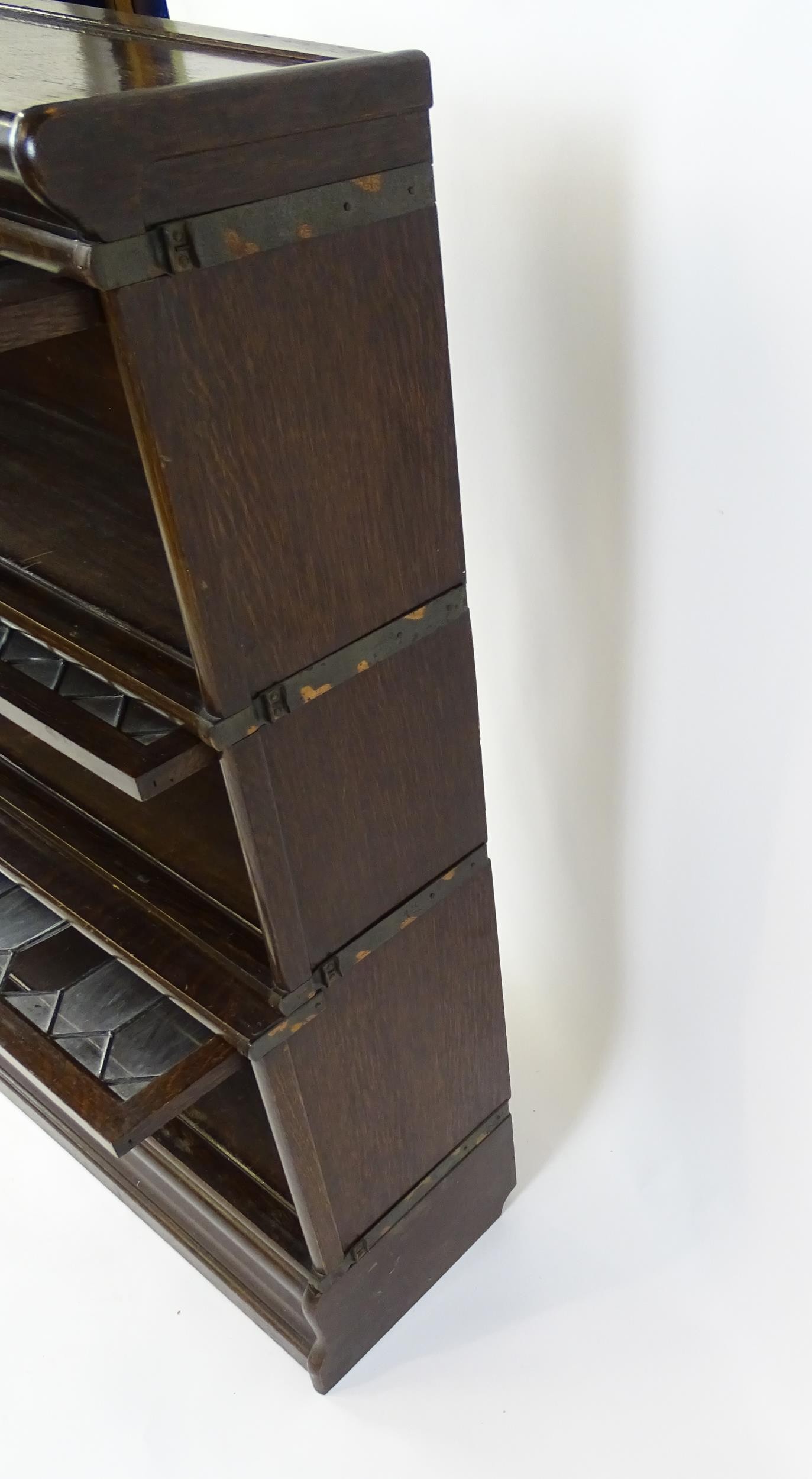 An early / mid 20thC oak Globe Wernicke bookcase with three glazed tiers above a shaped base. 34" - Image 7 of 8