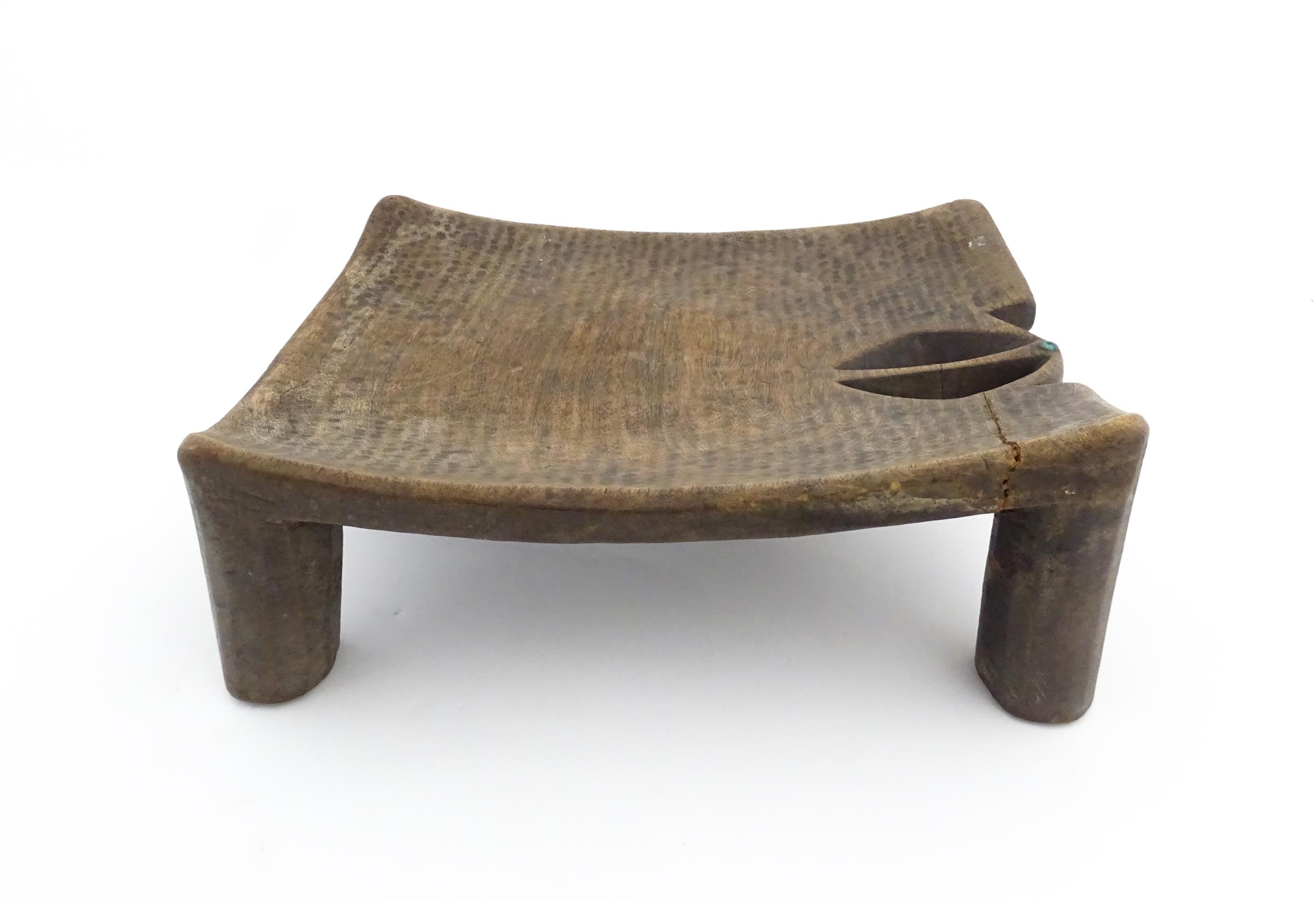 Ethnographic / Native / Tribal: An African carved wooden stool with pierced decoration, raised on - Image 2 of 7