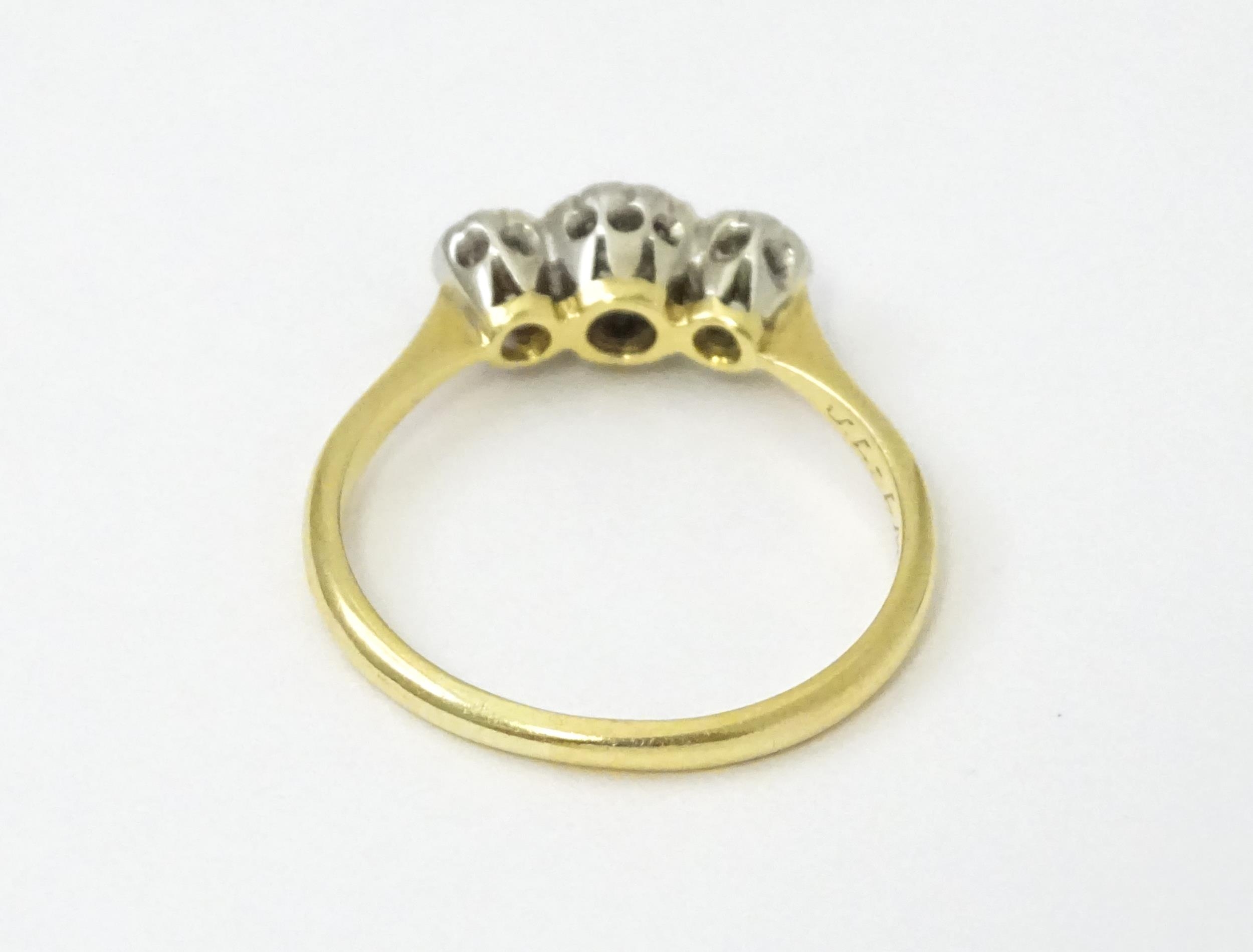 An 18ct gold ring with three platinum set diamonds. Ring size approx. O Please Note - we do not make - Image 13 of 18