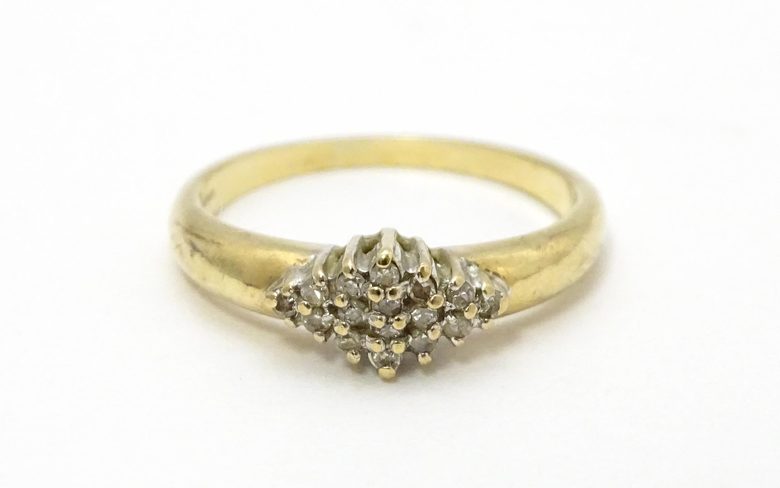 A 9ct gold ring set with diamond cluster. Ring size approx. K 1/2 Please Note - we do not make