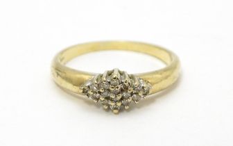 A 9ct gold ring set with diamond cluster. Ring size approx. K 1/2 Please Note - we do not make
