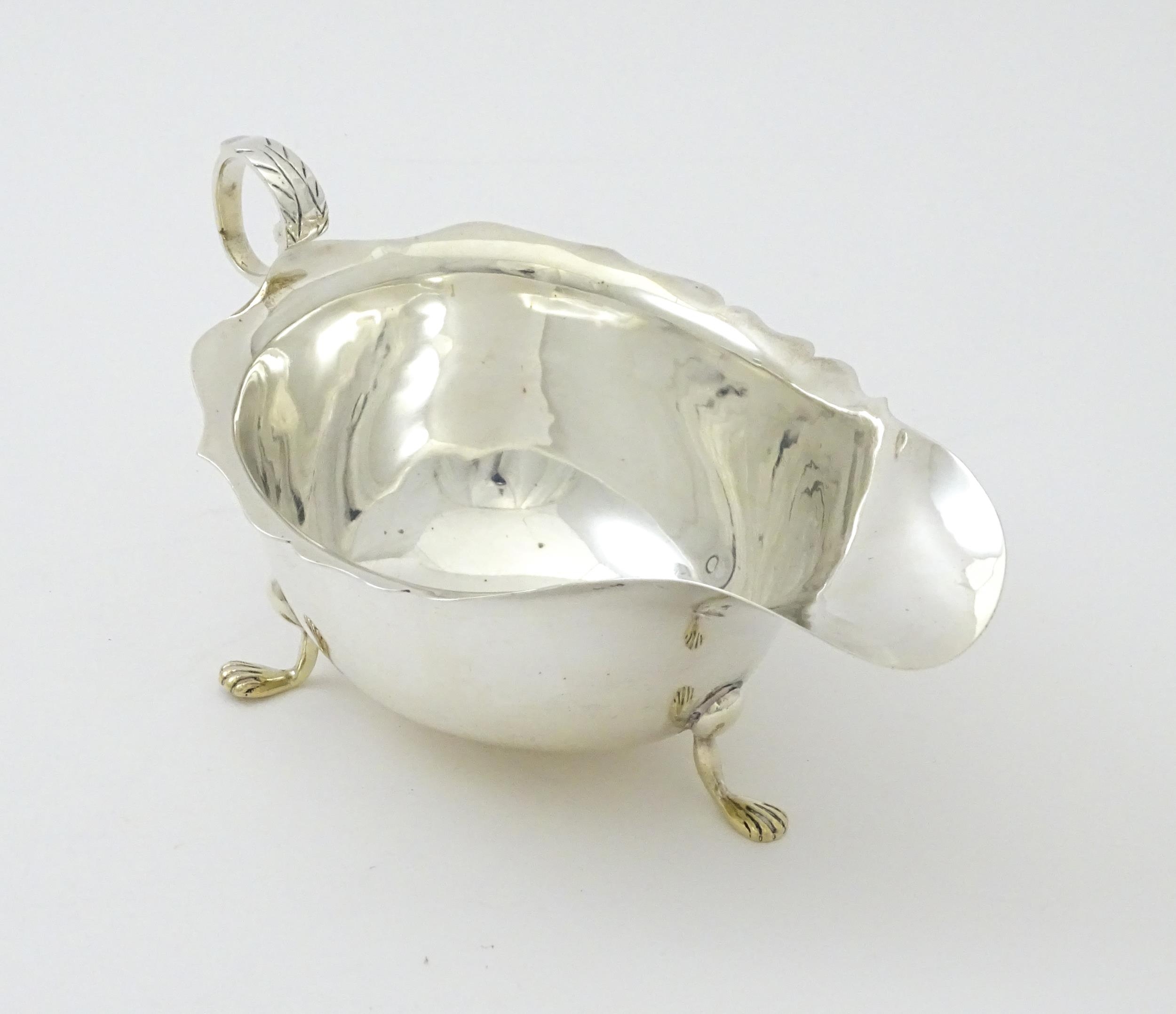 A silver sauce boat hallmarked Chester 1905, maker George Nathan & Ridley Hayes. Approx. 5 3/4" long