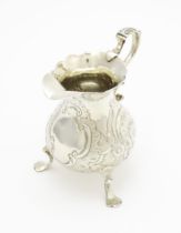 A Geo III silver cream jug with engraved decoration, hallmarked London 1751. Approx. 3 1/4" high