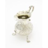 A Geo III silver cream jug with engraved decoration, hallmarked London 1751. Approx. 3 1/4" high