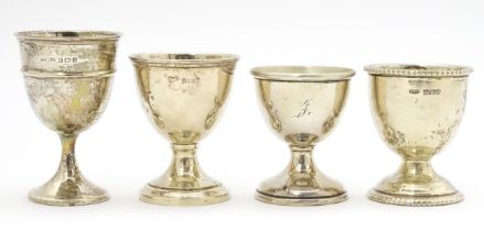 Four assorted silver egg cups hallmarks to include Birmingham 1912, maker S Blanckensee Ltd,