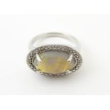 A silver ring set with opal cabochon. Ring size approx. P Please Note - we do not make reference