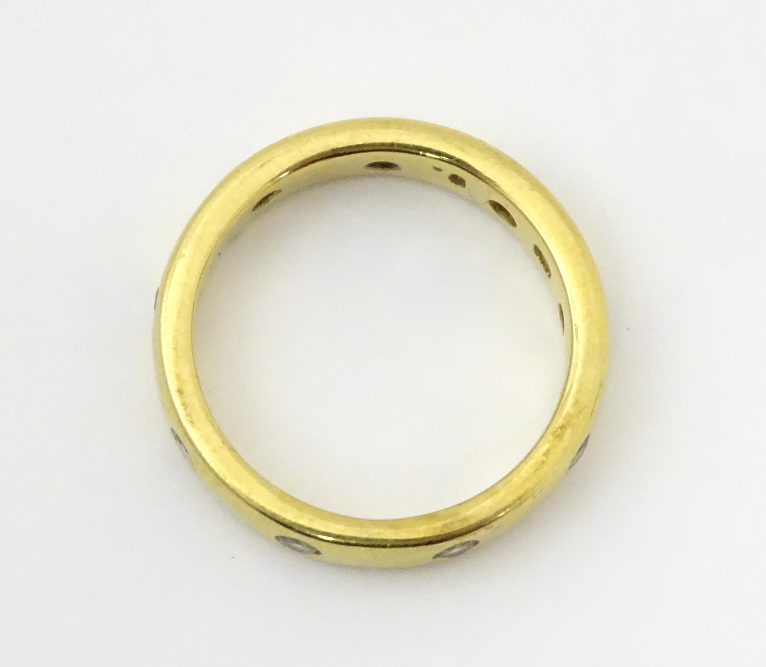 A yellow metal eternity ring set with white stones. Ring size approx. Q 1/2 Please Note - we do - Image 2 of 6