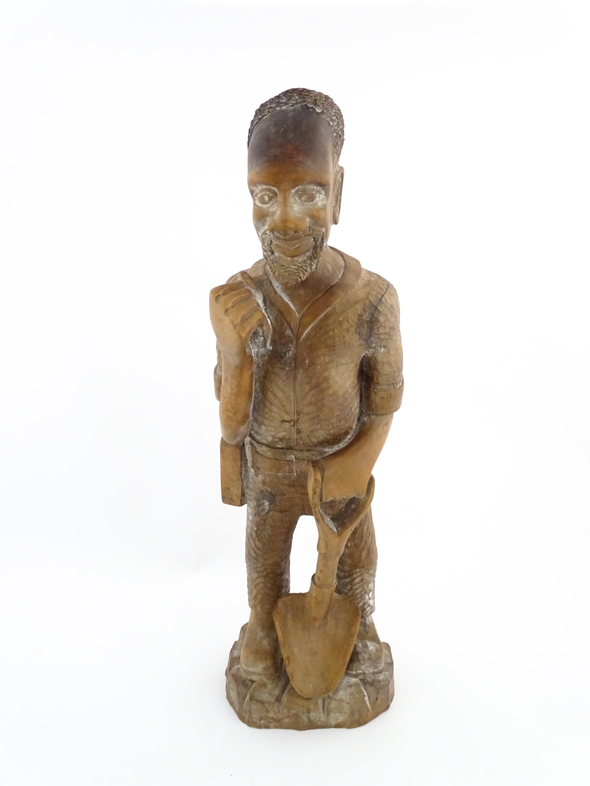 Ethnographic / Native / Tribal: An African carved wood figure modelled as a male farmer with a