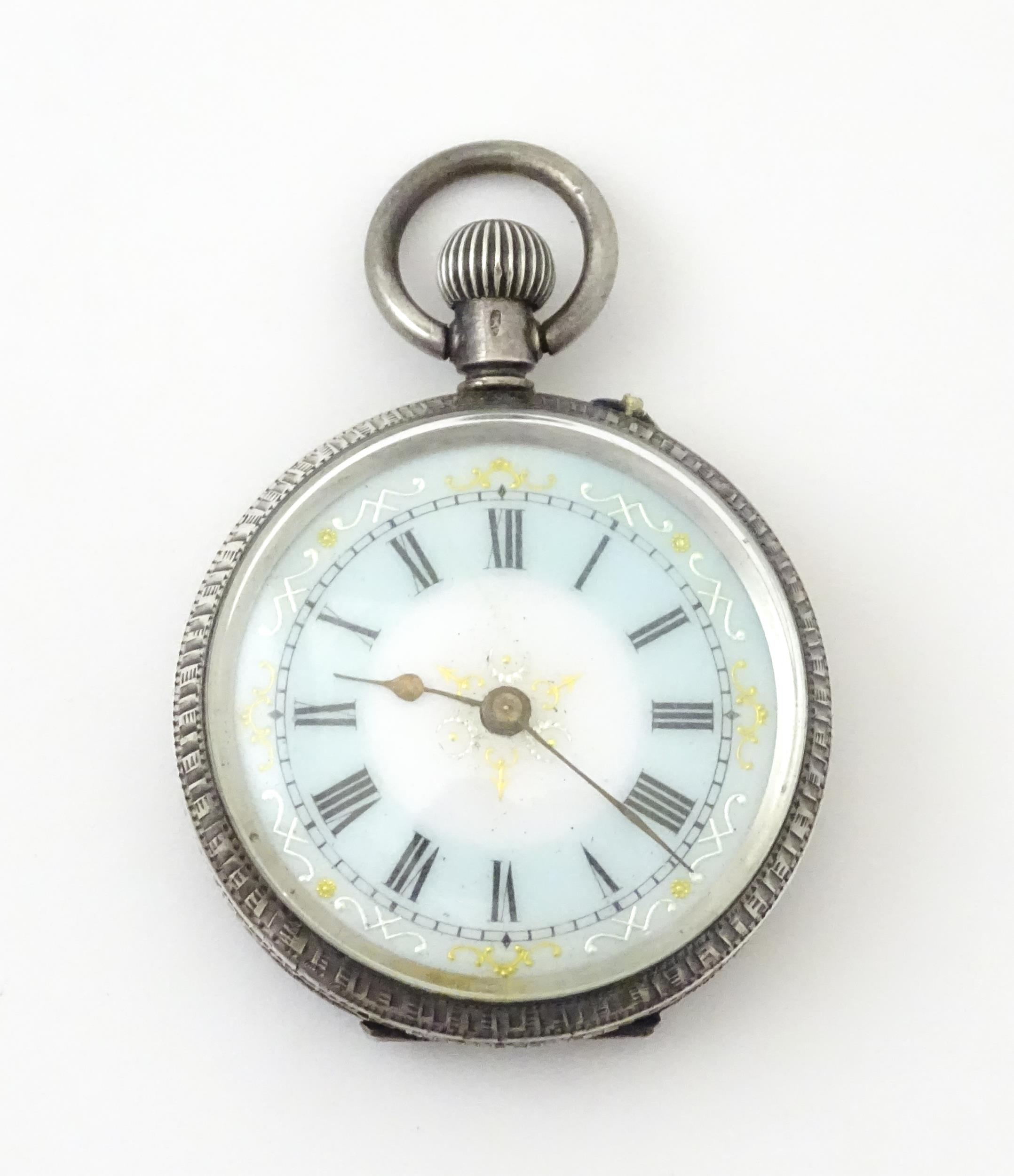A Swiss silver cased pocket / fob watch with enamel detail and Roman Numerals. Approx 1 /4" wide