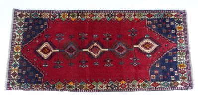 Carpet / Rug: A South West Persian Qashqai rug the red ground decorated with geometric motifs.