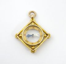 A 9ct gold compass of pendant / fob form. Approx 1 1/2" long Please Note - we do not make