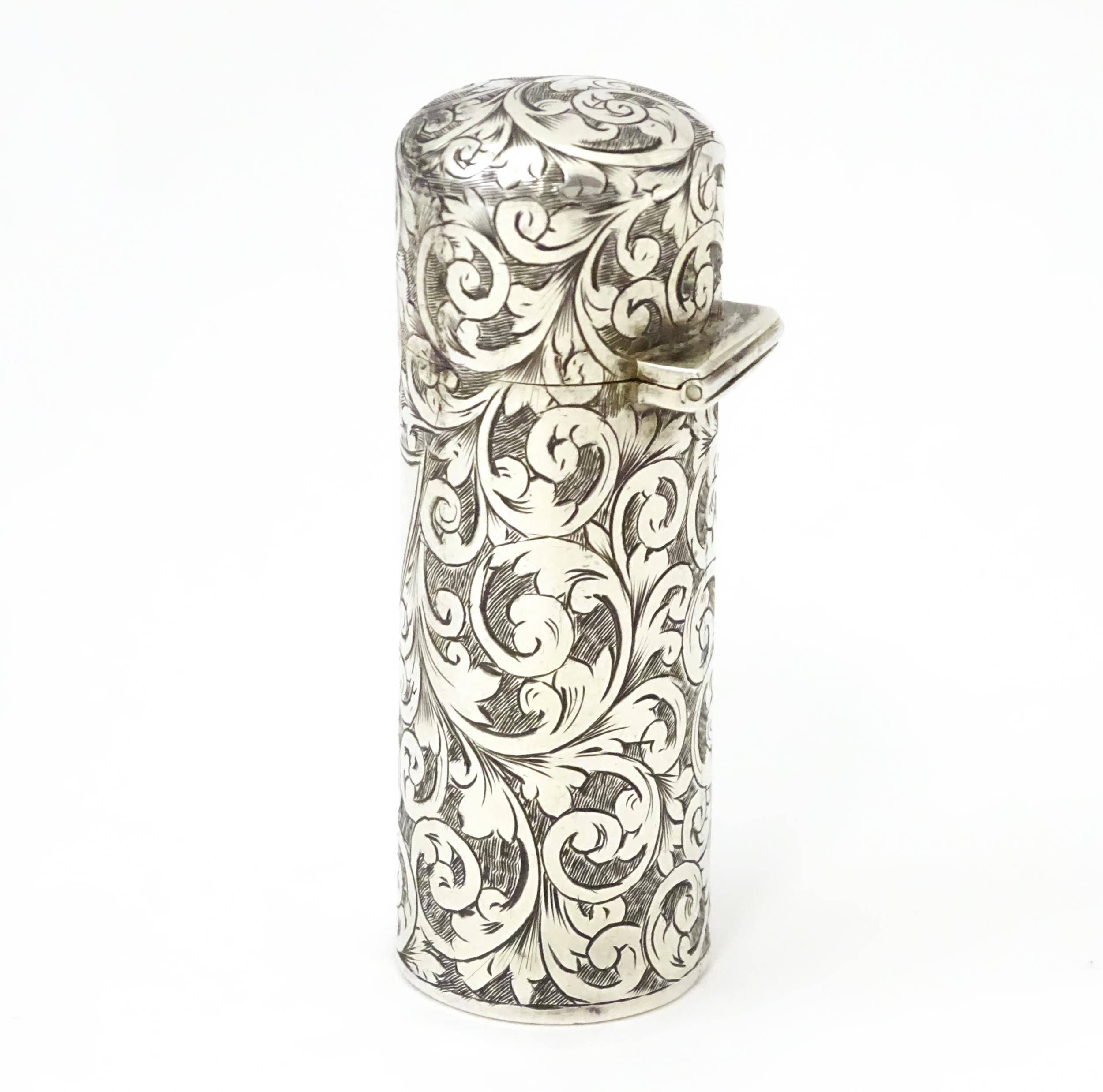 A silver scent / perfume bottle with engraved decoration opening to reveal gilded interior and - Image 4 of 9